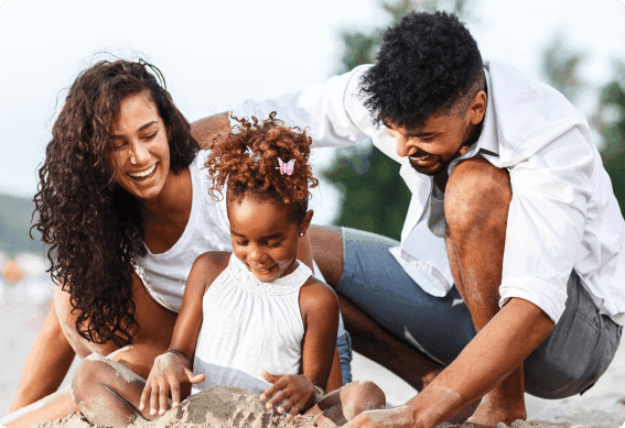 a family playing with sand