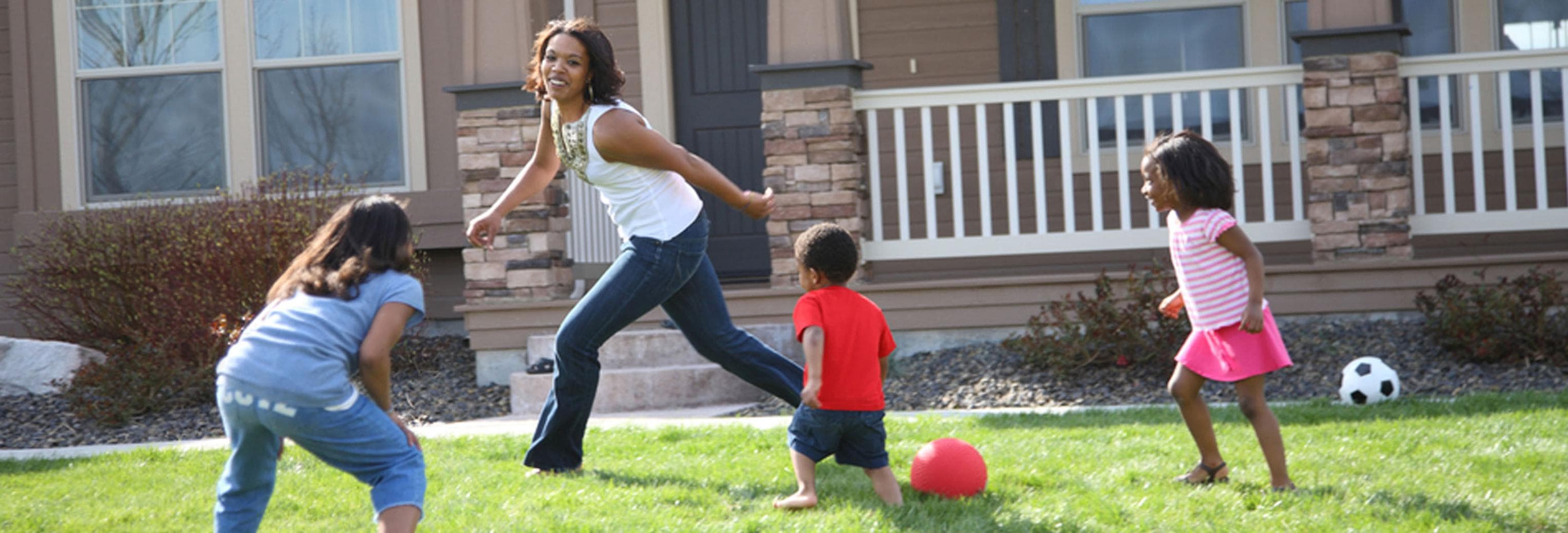 a family playing a game in the front yard