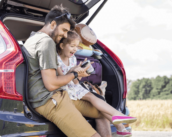 Father and daughter in back of SUV