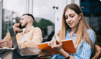 a man and a woman looking at a laptop